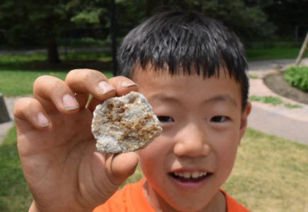 Child Holding Rock