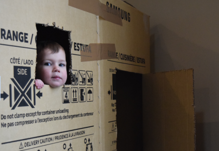 kid poking head out of box