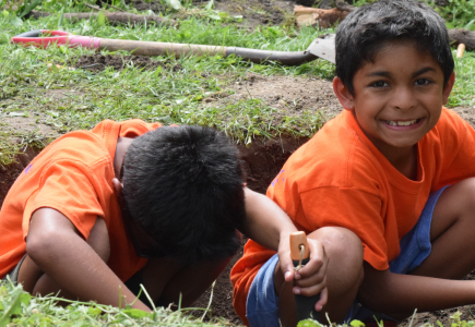 two boys digging in the dirt