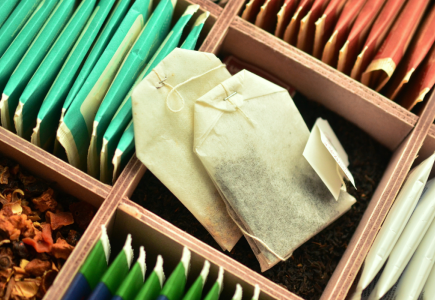 box with various packaged teas and loose leaf and two tea bags centred