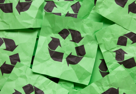 many green crinkled papers with black recycling logos