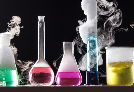 various beakers with coloured liquids at the bottom and smoke coming out the top