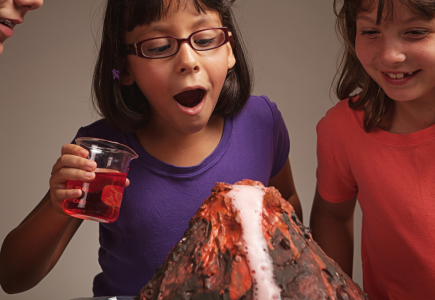 three children reacting to a baking soda volcano