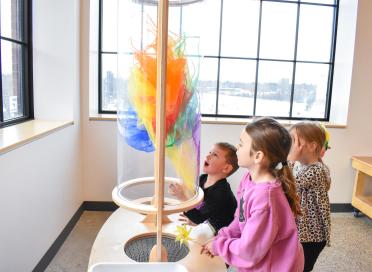 Children play with wind tunnel in Discovery Lab