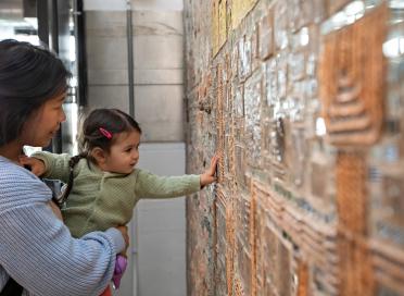 Child explores mosaic