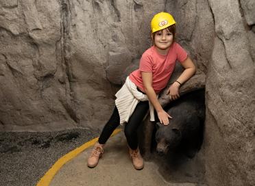 child in hard hat in Unearthed exhibit