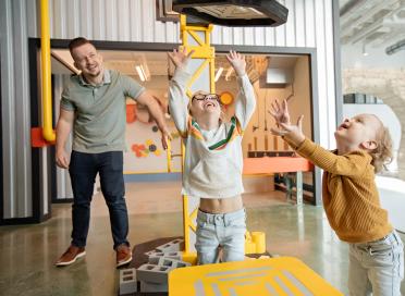 Children play in Farm Works with Crane